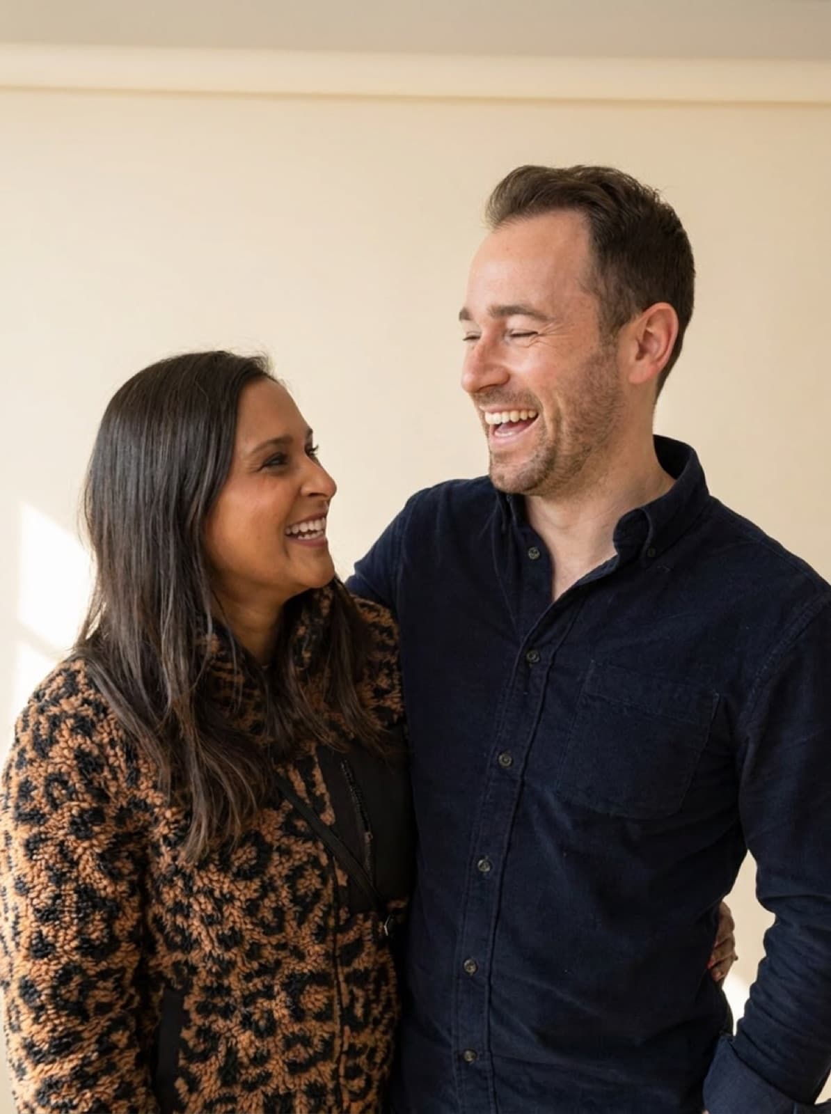 Rami and Melissa, the couple behind the KOTS origin story, laughing together